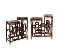 A PAIR OF CHINESE CARVED HARDWOOD TWO TIER TABLES