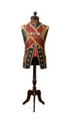 A DRESS STAND DESIGNED AS A 19TH CENTURY MILITARY UNIFORM