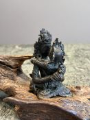 AN 18TH / 19TH CENTURY TIBETAN BRONZE FIGURE OF HERUKA ON SANDALWOOD BASE A
