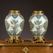 A PAIR OF 19TH CENTURY PORCELAIN VASES WITH ORMOLU MOUNTS