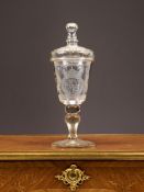 AN ENGRAVED GLASS GOBLET AND COVER WITH ROYAL CREST