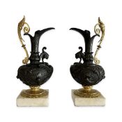 A PAIR OF 19TH CENTURY GILT AND PATINTED BRONZE EWERS