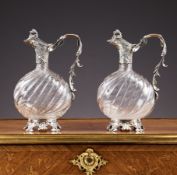 A FINE PAIR OF LATE 19TH CENTURY FRENCH SILVER AND GLASS CLARET JUGS