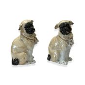 A PAIR OF PORCELAIN MODELS OF SEATED PUG DOGS