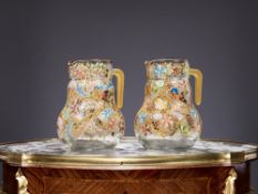 A PAIR OF MOSER STYLE ENAMELLED GLASS JUGS