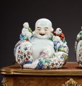 A CHINESE FAMILLE ROSE PORCELAIN FIGURE OF THE LAUGHING BUDDHA