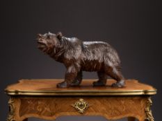 A 19TH CENTURY BLACK FOREST CARVED WOOD MODEL OF A WALKING BEAR