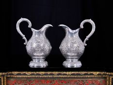 A FINE PAIR OF ANTQUE GERMAN SILVER CLARET JUGS