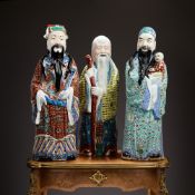 THREE CHINESE FAMILLE ROSE GLAZED FIGURES OF DEITIES