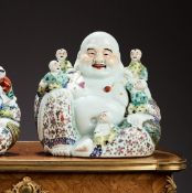 A CHINESE FAMILLE ROSE PORCELAIN FIGURE OF THE LAUGHING BUDDHA