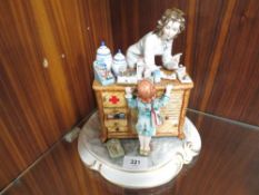 Two capodimonte figures one of a girl in a pharmacist together with a doctor figurine (2)