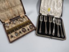 A cased set of hallmarked silver cake forks approx weight 120g together with a set of silver