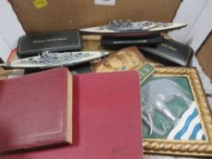 A box of militaria to include a HMS Ganges plaque, 1907 signal training manual, a 1914 map reading