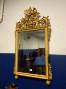 A modern carved wall mirror H 110 cm