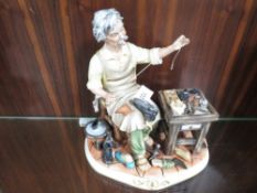 A Capodimonte figure of a cobbler at work