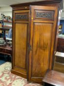 An antique two door mahogany wardrobe