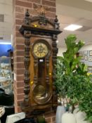 An antique Vienna dog bone wall clock with eagle finial H 130 cm