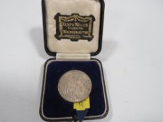 A 1915 silver half crown, in period presentation case of Kemp & Wilcox Goldsmiths Wolverhampton