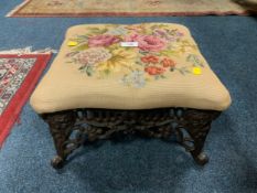 A small cast stool with tapestry top