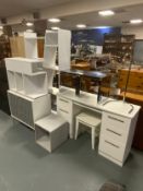 A white angular modern bookcase together with a dressing table, chest, stool etc…