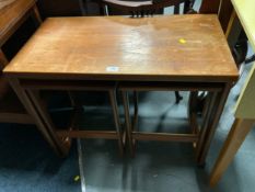 A vintage fold over teak nest of tables