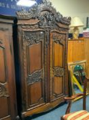 A large carved mahogany armoire H 247 cm W 132 cm
