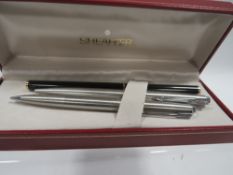 A Shaffer fountain pen with two Parker pens