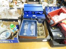 Four assorted trays of mixed glassware to include a Murano style clown and boxed wine glass examples