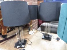 A pair of glass decorative ex-show home lamps together with a wooden example (3)