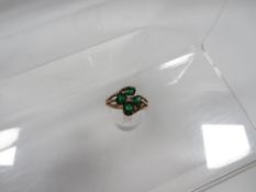 A 9 carat gold four leaf clover style ring set with greenstones approx weight 3.6g
