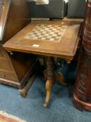 An antique oak pedestal games table