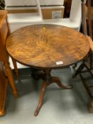 An antique tilt top pedestal table