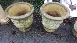 A pair of matching concrete garden planters