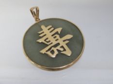 A hallmarked 9 carat gold and jade Chinese pendant dia 3cm