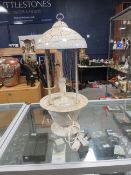 A vintage 'lady in the rain' oil lamp