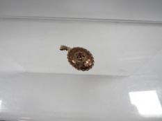 A hallmarked 9 carat gold pendant locket set with rubies, approx weight 2.8g