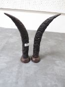 A pair of resin style carved tusk design display pieces