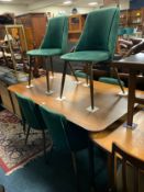 A show home dining table with six green modern chairs