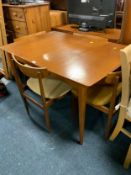 A mid century teak table and four chairs