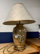 A decorative gilt table lamp and shade