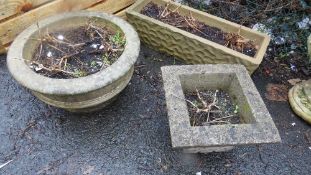 A selection of three concrete garden planters
