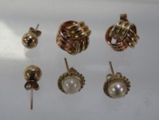 A selection of gold and yellow metal earrings