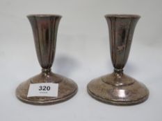 A pair of American silver candlesticks with filled bases by Black Starr & Gorham