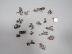 A bag of assorted silver and white metal charms