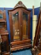A carved mahogany glazed display cabinet with a single drawer H 210 cm W 99 cm