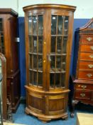 A large mahogany glazed floor standing corner cabinet