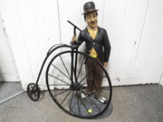 A Novelty figure of a man with a penny Farthing