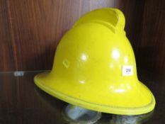 A vintage fire helmet in yellow