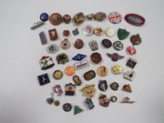 A bag of assorted enamel badges and medallions etc
