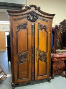 A large Continental style carved armoire H 237 cm W 134 cm